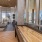 a room with a large window and a large deck with a view of the city