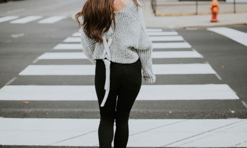 Close to the center of everything a person walking in a crosswalk