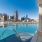 a pool with a city in the background