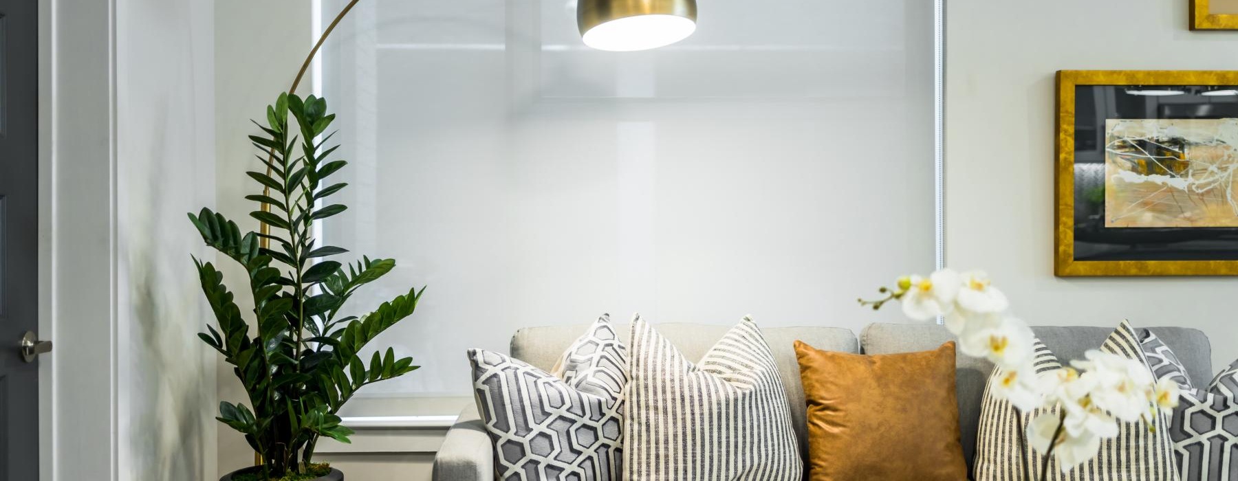 a white couch with a chandelier above it