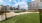 a grassy area with buildings in the background