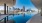 a pool of water with a city in the background