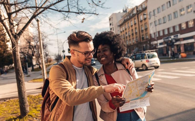 Close to the center of everything a man and woman looking at a map in the city